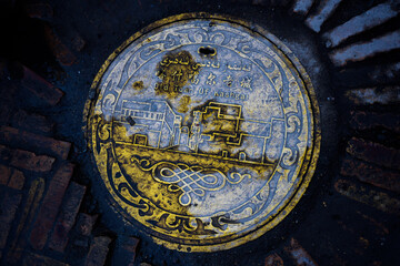 Metal manhole cover in the old town of Kashgar, Xinjiang Province, China