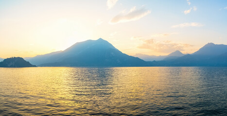 Panoramic view of sunset behind Alps mountains and Como lake