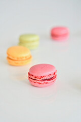 Cake macaron or macaroon on white background, sweet and colorful almond cookies with various pastel colors, vintage look. Different types of macaroons are a delicious dessert.