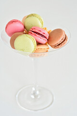 Cake macaron or macaroon on white background, sweet and colorful almond cookies with various pastel colors, vintage look. Different types of macaroons are a delicious dessert.