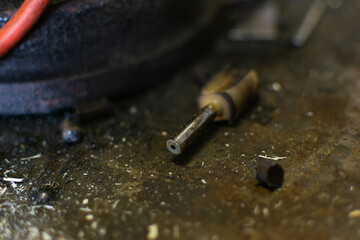 Fototapeta na wymiar a stray rounter bit on a dusty workbench in a fabrication shop