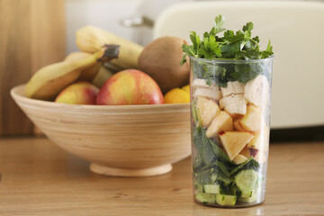 Cooking healthy detox smoothie with fresh fruits and green spinach. Healthy Lifestyle detox concept. ingredients needed for green detox smoothie on the kitchen