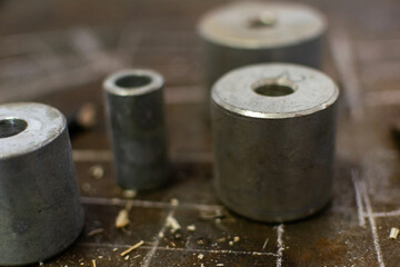 four machining dies on a workbench in a fabrication shop