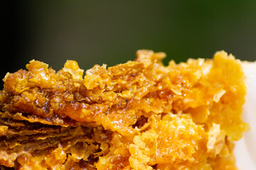 raw beeswax after being cut from the beehive frames