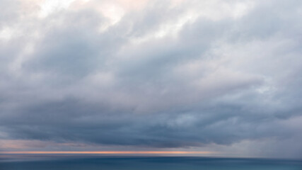 Aerial view of dramatic rain clouds over Tasman sea horizon