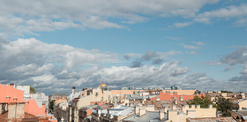 Sunset view at the Isaak Cathedral from the roof of Saint-Petersburg city. Ancient roof of the city. Old historical city. Amazing sunset at the top of the city