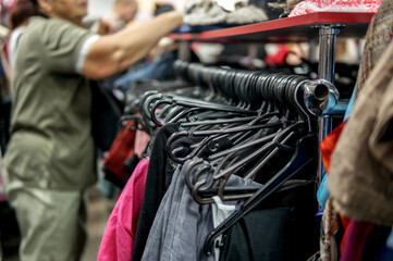 Fototapeta na wymiar choosing clothes at flea market