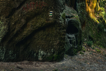 Moody landscape photo of rock formation that looks like half of skull in protected natural region in Czech Republic. April 2017.