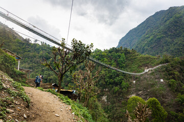 Long Pedestrian Suspension Bridge in Nepal Jungle on Annapurna Base Camp Trek