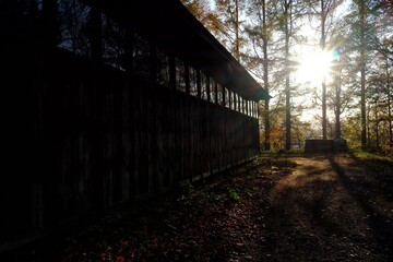 Fototapeta na wymiar Wooden Barn in Autumn Sunrise Background.