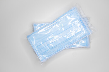 Blue and clean new face masks protection against covid19  frontal view envelope in plastic