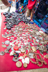Metal Trinkets on a Red Tablecloth at Village in Nepal