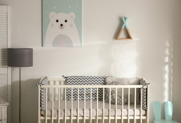 Cute baby room interior with crib and decor elements