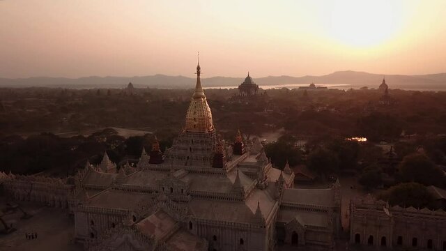 Orbit Aerial View of Ancient Buddhist Shrine in Bagan City, Myanmar. Ananda Temple Under Golden Hour Sunlight