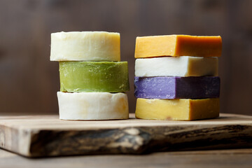Traditional organic turkish handmade colored soap bars on a brown wooden background.