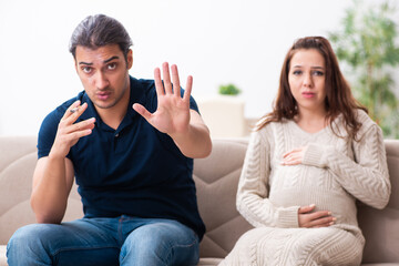 Man and pregnant woman in antismoking concept