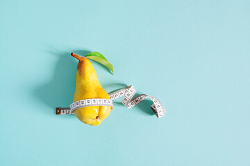 Weight loss concept, yellow pear checks body shapes with measuring tape - 353899695