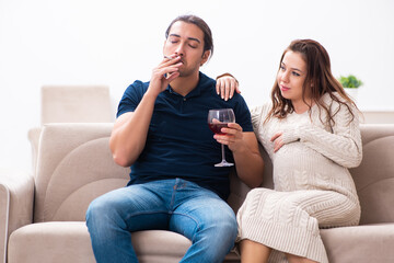 Man and pregnant woman in harmful habits concept
