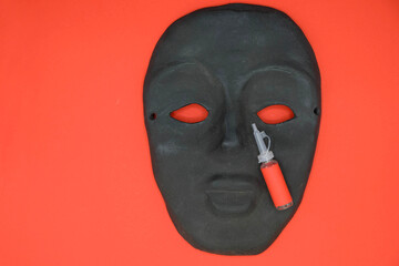 Black silhouette of a face on a red background. On the face of a medical container with eye drops. Copy space. Mock-up.  Minimalism.