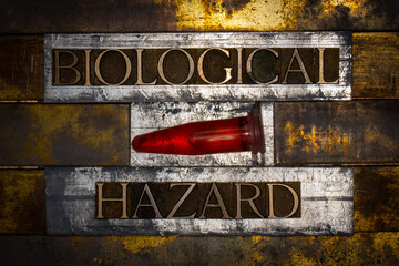 Photo of real authentic typeset letters forming Biological Hazard text on vintage textured silver...