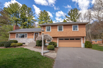 exterior tri-level residential home in suburbs with garage