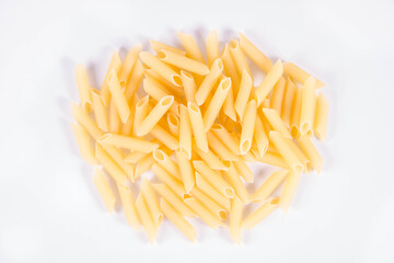 Raw penne pasta on a white background