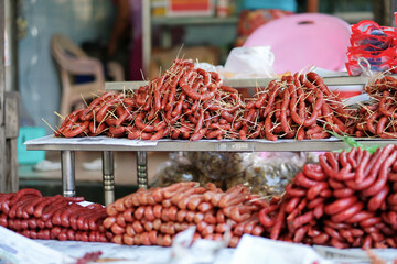 Meat products and street foods on table local shop in Zegyo Market at morning. Mandalay, Myanmar