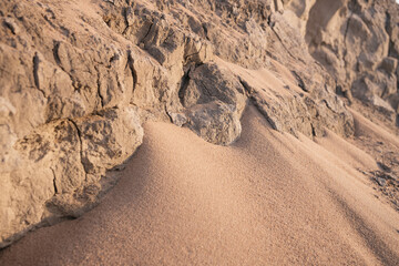 Fototapeta na wymiar Clay rocks and sand closeup in the soft evening light