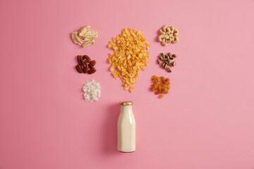 Healthy breakfast, dieting, clean eating or food concept. Cereals and other nutrient ingredients for making morning snack. Dried fruits and nuts can be added to porridge. Top view. Preparing muesli.