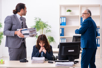 Two male and one female employees working in the office