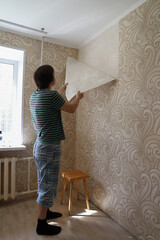 Moscow Russia-may 2020: renovation in a new apartment by new residents, tear the Wallpaper off the wall