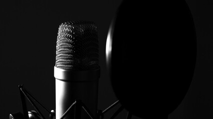 Studio condenser vocal mic - professional recording studio equipment - black background - obrazy, fototapety, plakaty