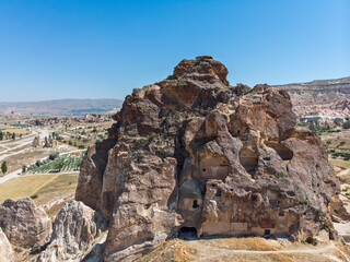 Aerial view of Goreme National Park, Tarihi Milli Parki, Turkey. The typical rock formations of Cappadocia with fairy chimneys and desert landscape. Travel destinations, holidays and adventure
