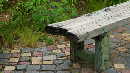 Fototapeta premium the appearance of an old, decaying wooden bench with paint peeling and rotting.