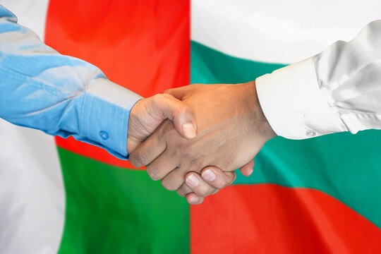 Handshake on Madagascar and Bulgaria flag background. Support concept.