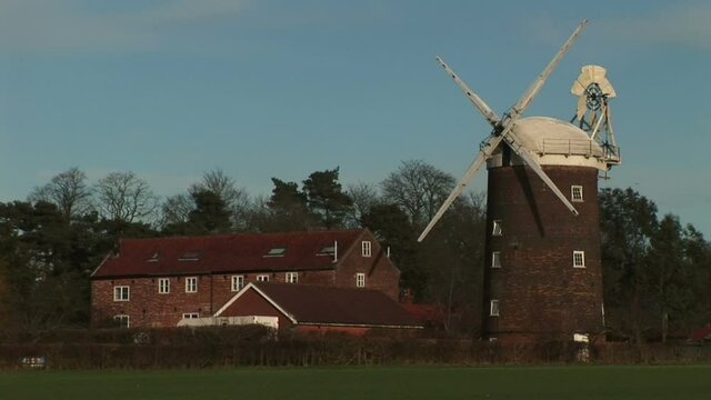 England countryside with windmill in Norfolk Broads UK