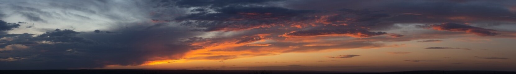 Fototapeta na wymiar Purple-magenta clouds. Tragic gloomy sky. Landscape with bloody sunset. Fantastic skies on the planet earth. Twilight, nightfall.