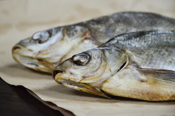Dried river fish on paper