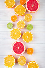 Citruses on white wooden background