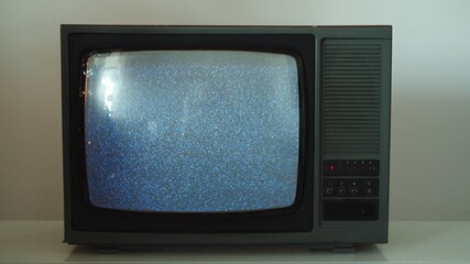 Old retro CRT television TV set with static noise snowing on screen - obrazy, fototapety, plakaty