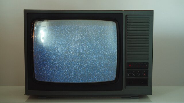 Old retro CRT television TV set with static noise snowing on screen