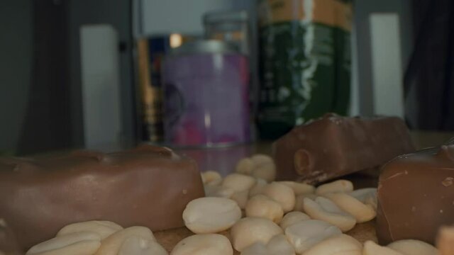 Macro close up view of the broken chocolate bar of chocolate with cashew nuts