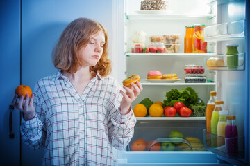 teenager girl at fridge with food