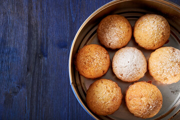 golden, treat, round, round box, tin box, cookie box, dark blue, blue, dark background, bake, carbs, flat lay food, flat layout, flat lay, basic, traditional, sugar, top view, powder, sprinkle, icing 