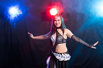 Portrait of a woman in oriental costume performing belly dance. Tribal fusion dance concept.
