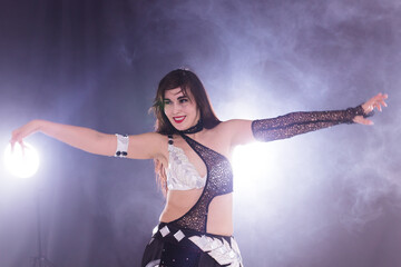 Girl dancing belly dance, fusion or tribal. A woman in a beautiful costume demonstrates charming and gentle movements in the dance.
