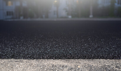 Road repair and thin layer of new asphalt close-up.
