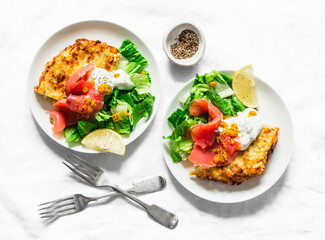 Potato tortilla with greek yogurt, smoked salmon and green salad on a light background, top view. Delicious breakfast, appetizer, tapas