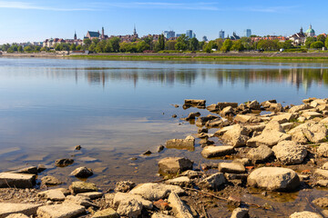 Panoramic view of Warsaw, Poland, city center and Old Town quarter with Wybrzerze Gdanskie embankment and wild banks of Vistula river - obrazy, fototapety, plakaty
