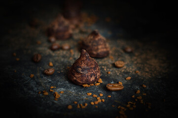 close-up of chocolate candy truffles on a dark background selective focus, coffee grains.